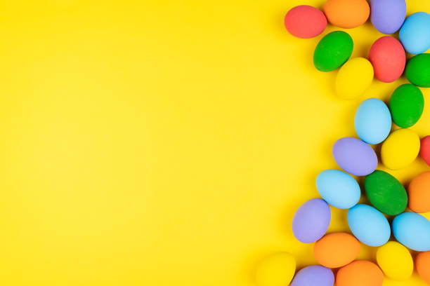 istock Easter day with decorated eggs on yellow background 1211996339