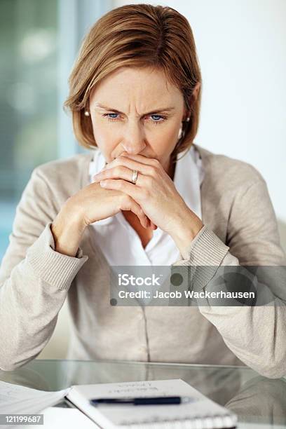 Disappointed Mature Businessswoman Thinking About Something Stock Photo - Download Image Now