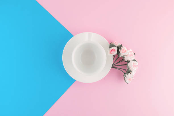 istock Empty coffee cup and flower on beautiful pink and bright blue pastel background. 1211998251