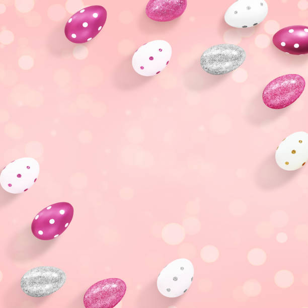 istock Square composition of silver, white and purple eggs with bokeh lights on a pastel pink background. Advertising content for the Easter holiday. Flat lay, top view, close up, copy space for your text 1211998351