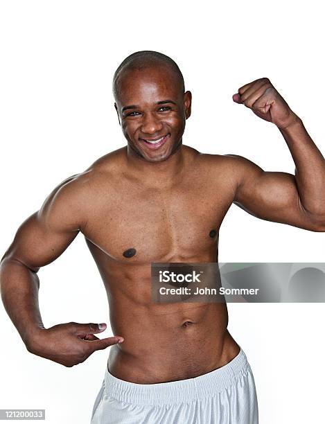 Man Flexing And Pointing To His Waist Stock Photo - Download Image Now - 20-24 Years, 20-29 Years, Abdominal Muscle