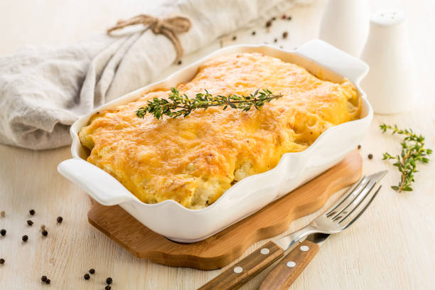 Casserole with cheese. Vegetable or meat lasagna baked in a beautiful deep white dish. stock photo