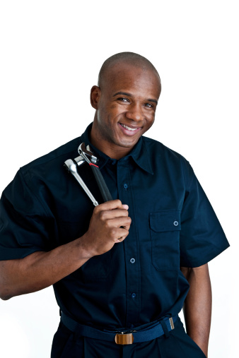 Man holding tools and wearing a mechanic uniform 