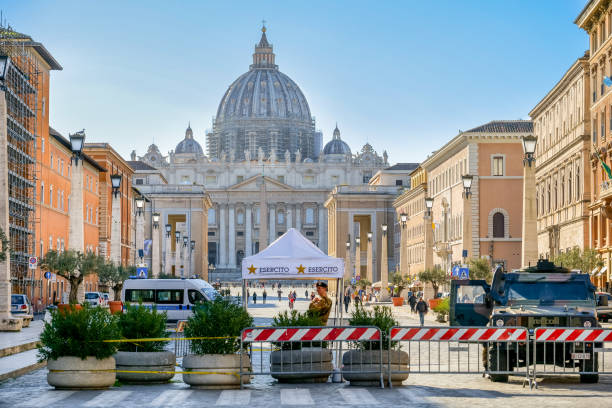 Some Italian soldiers guard the entrance to the Vatican with St. Peter's Basilica in the background Vatican, Italy, March 11 -- An armed patrol of the Italian Army control with a checkpoint the access to the square of St. Peter's Basilica along Via della Conciliazione. In the background the square and St. Peter's Basilica church of san pietro photos stock pictures, royalty-free photos & images