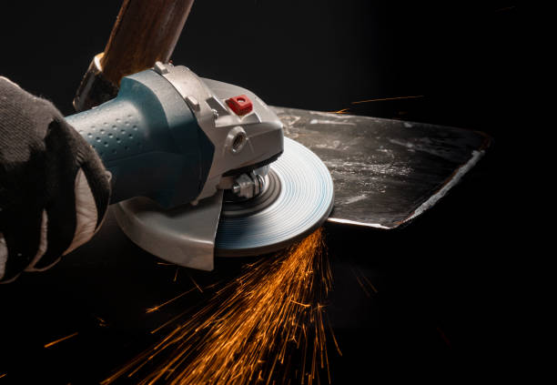 istock Sharpening garden shovel blade with electric angle grinder indoor 1212003628