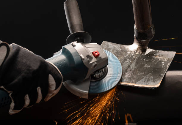 istock Sharpening garden shovel blade with electric angle grinder indoor 1212003633