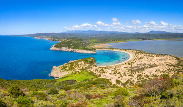 Aerial view of voidokilia beach ( Ox stomach bay or Ochsenbauchbucht ) - Bay of Ionian Sea near Pylos - Messenia - Peloponnese region of Greece Panoramic aerial view of voidokilia beach, one of the best beaches in mediterranean Europe. Seen from from the Palaiokastro. Voidokilia Beach is a popular beach in Messinia in the Mediterranean area. In the shape of the Greek letter omega (Ω), its sand forms a semicircular strip of dunes. On the land-facing side of the strip of dunes is Gialova Lagoon, an important bird habitat. The beach has been named "A Place of Particular Natural Beauty". view into land stock pictures, royalty-free photos & images