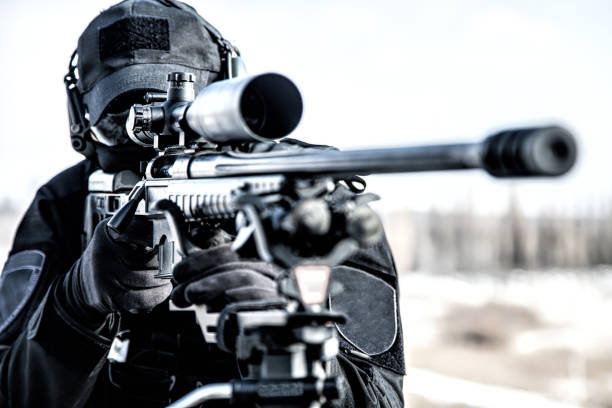 Equipped police SWAT sniper shooting with rifle stock photo