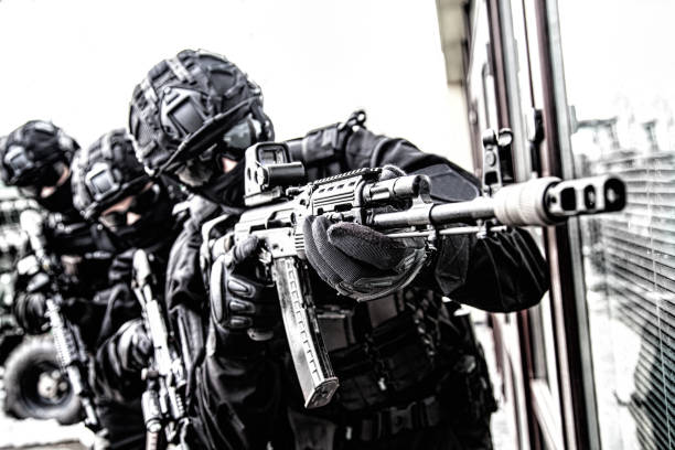 istock Police special reaction team member aims with gun 1212003755