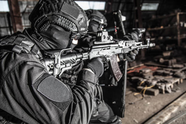 istock Police special reaction team squad attacking criminals 1212003776