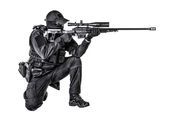 Police special forces, security operations team, SWAT group sniper in blank black uniforms, sitting and aiming with sniper rifle equipped telescopic optical sight, isolated on white studio shoot