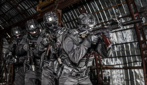 istock Police tactical group sneaking in industrial area 1212004410