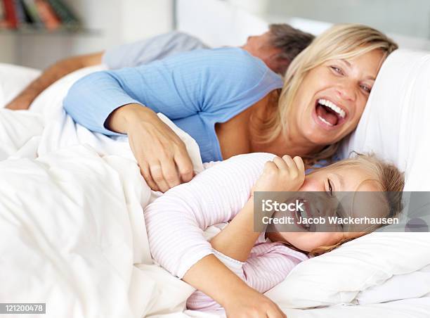 Happy Family Having Fun In Morning On Bed Stock Photo - Download Image Now - Bed - Furniture, Family, Two Parents