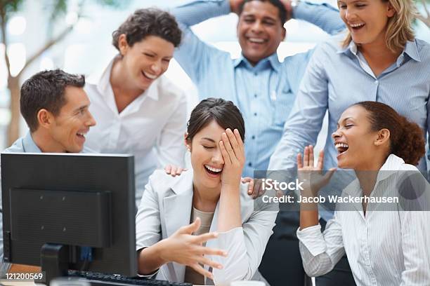 Colleagues Enjoying Laugh On A Funny Email Stock Photo - Download Image Now - Hand On Shoulder, Happiness, Multiracial Person