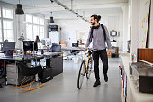 Businessman with a bicycle in office