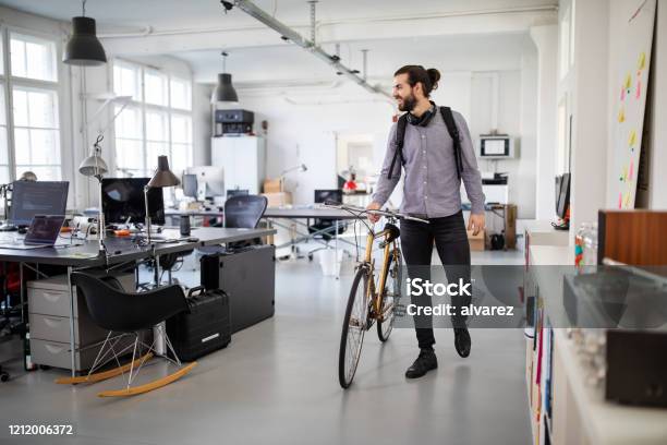 Businessman With A Bicycle In Office Stock Photo - Download Image Now - Office, Working, Bicycle