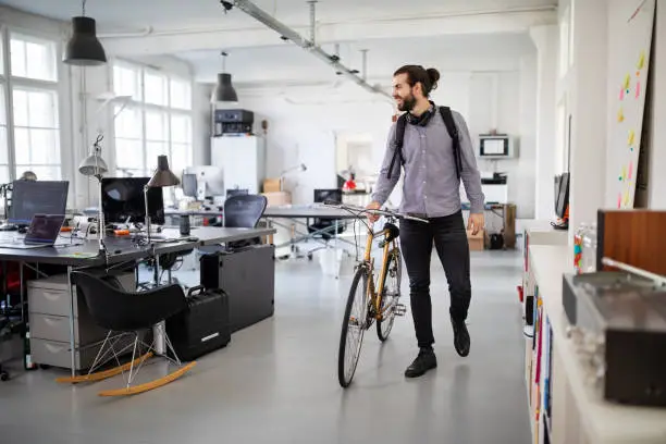 Photo of Businessman with a bicycle in office