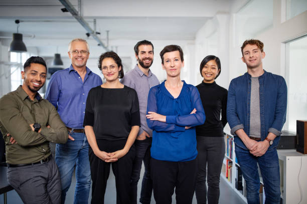 Portrait of a diverse business team Portrait of a diverse business team looking at camera. Multi-ethnic group of business people standing in office. looking at camera photos stock pictures, royalty-free photos & images