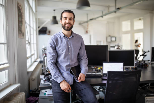 istock Young businessman standing at his workplace 1212006394
