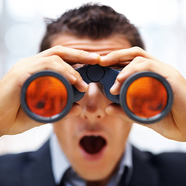 istock Shocked young male entrepreneur looking through binoculars 121200702
