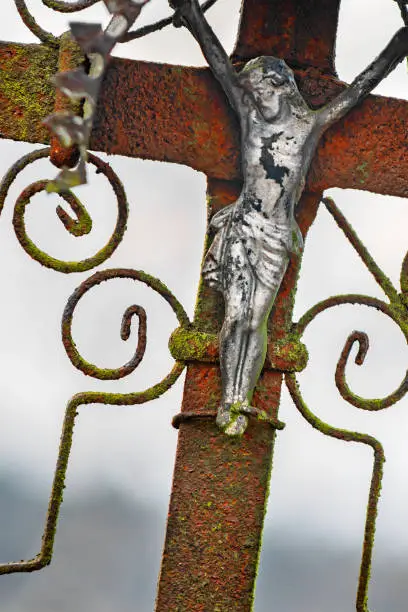 Photo of Close view of a metal crucifix on an old rusty metal cross