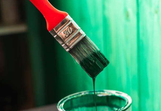 istock Painting wooden surface with a paintbrush 1212007731