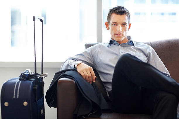 istock Young business executive waiting for his flight at airport 121200843