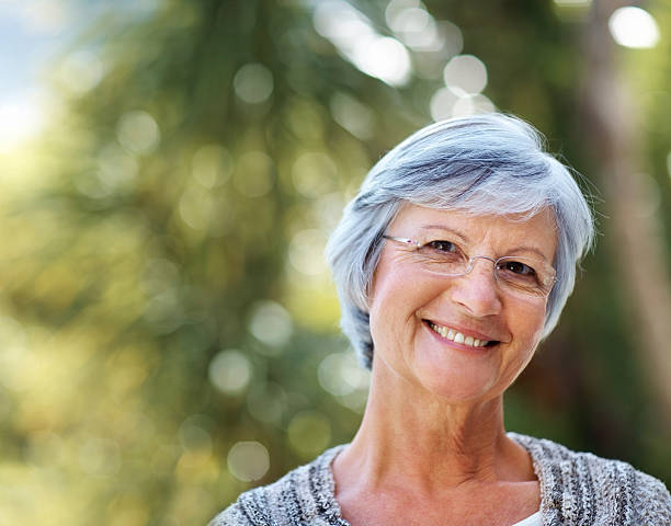 istock Attractive elderly woman smiling in the park 121200900
