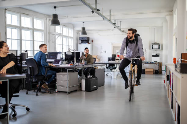 istock Man riding home on a bike from office 1212010106
