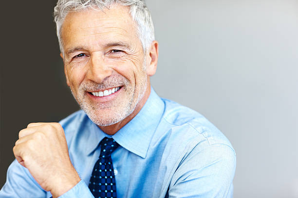 Successful mature business man smiling - Copyspace  mid adult men stock pictures, royalty-free photos & images