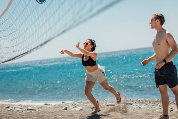 istock Friends playing beach volleyball together 1212014367