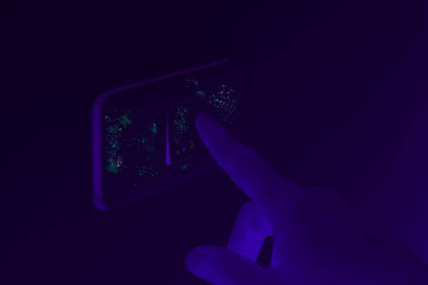 istock Germs and harmful infectious bacteria exposed under UV black light on domestic home light switch 1212014550