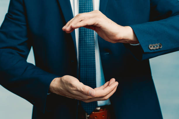 istock Hands of a man in a blue jacket folded in the shape of a sphere or as if pulling something. 1212017667
