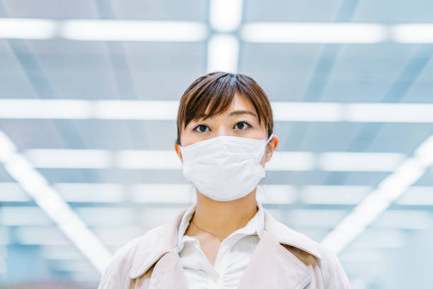 istock Businesswoman wearing protective surgical mask 1212018097