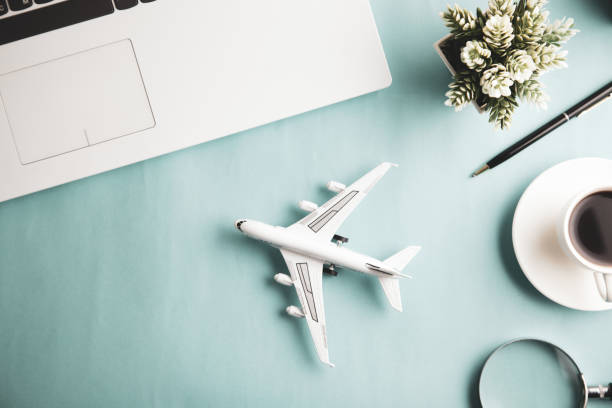 istock airplane with keyboard and coffee on the desk 1212019397