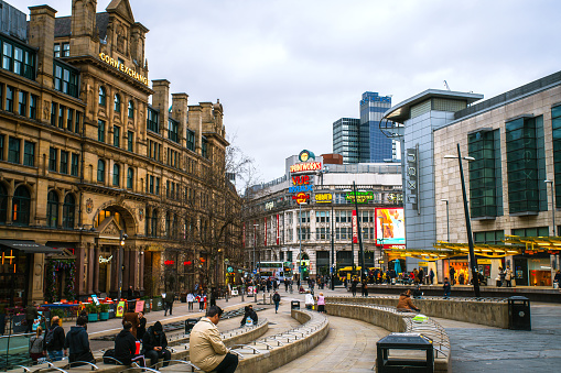 Manchester, England, UK - March 22, 2019 - Street view of Exchange Square, civic square and a major shopping area in Manchester