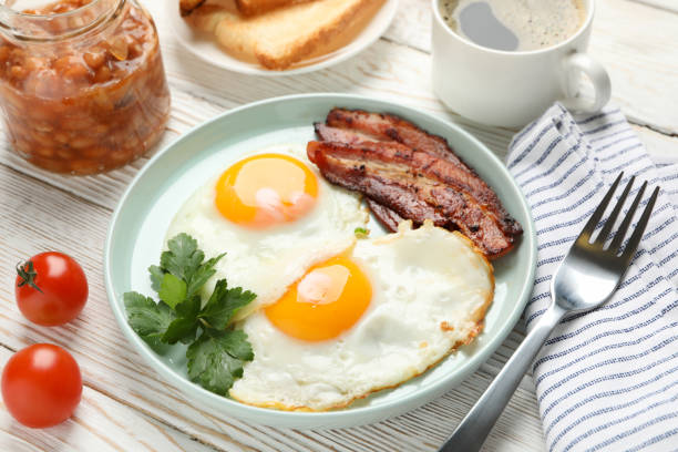 istock Delicious breakfast or lunch with fried eggs on wooden background, close up 1212021384