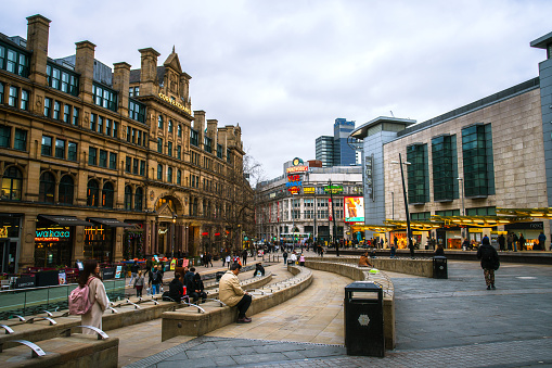 Manchester, England, UK - March 22, 2019 - Street view of Exchange Square, civic square and a major shopping area in Manchester