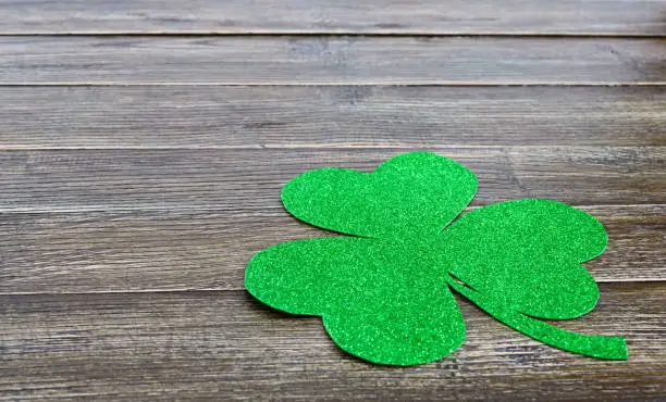 Green shamrock on a wooden background. St.Patrick 's Day background. Symbol of Ireland