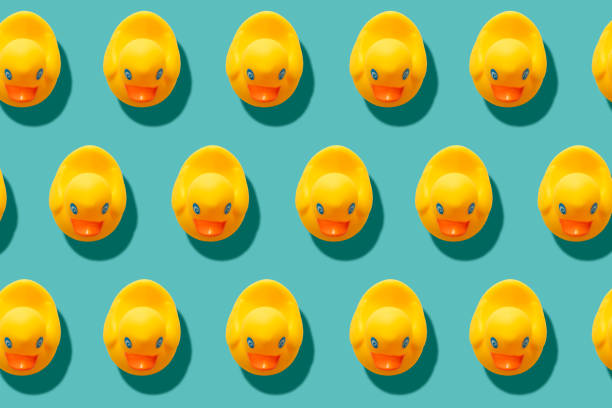 istock yellow rubber ducks on turquoise blue background 1212021482