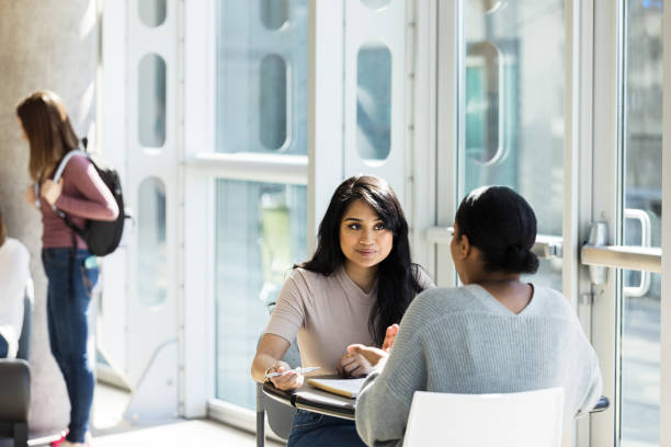 istock Serious female college students study together 1212021515