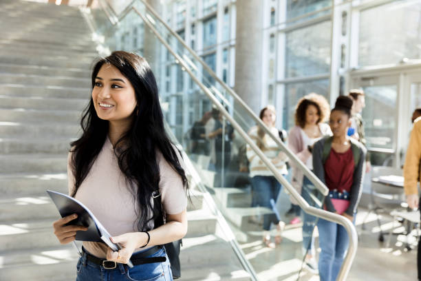 istock Cheerful Hispanic college student walks to class 1212021553