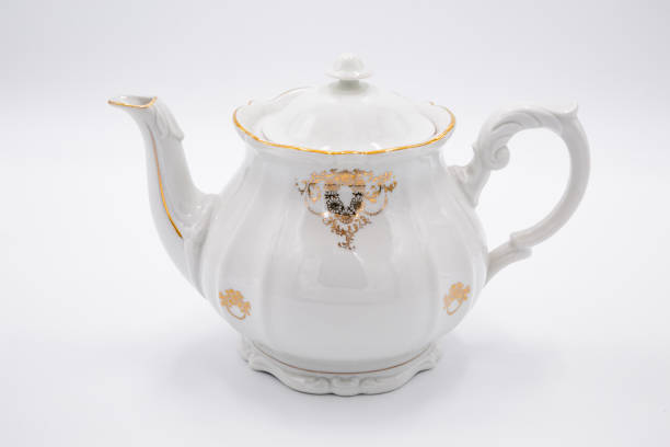 istock White teapot with golden design 1212022673