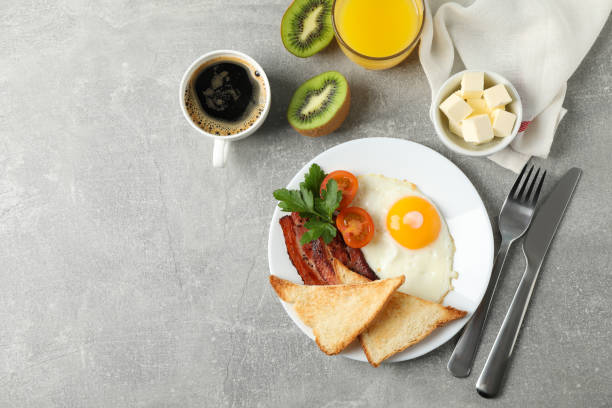 istock Delicious breakfast or lunch with fried eggs on grey background, top view 1212022753