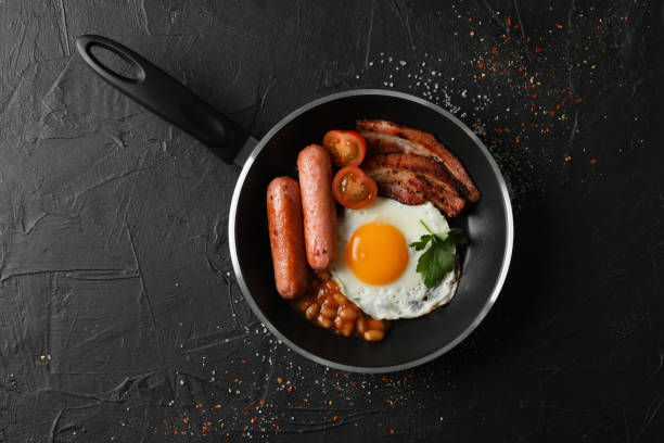 istock Delicious breakfast or lunch with fried eggs on black background, top view 1212023586