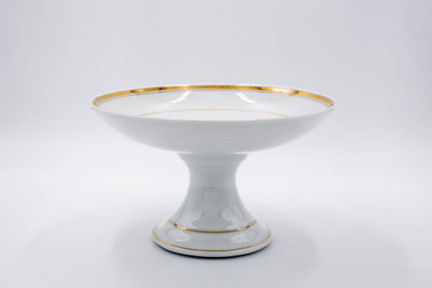 Antique glass fruit bowl isolated with golden rim Antique glass fruit bowl isolated with golden rim on white background antique fruit bowl stock pictures, royalty-free photos & images