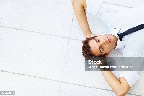 Relaxed Young Businessman Lying On Floor Stock Photo - Download Image Now - Lying Down, Lying On Back, One Person