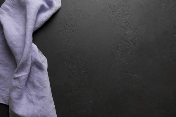 istock Kitchen black table with lilac tablecloth and space for your recipe or menu. Top view. flat lay 1212025590