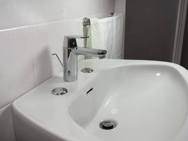 istock tap faucet in basin 1212025909