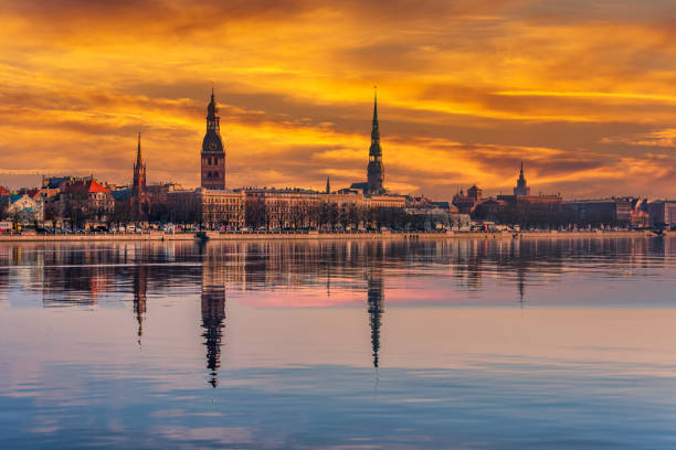 istock Cityscape of Riga Latvia with Reflections on a Quiet Still River at Sunset 1212026041